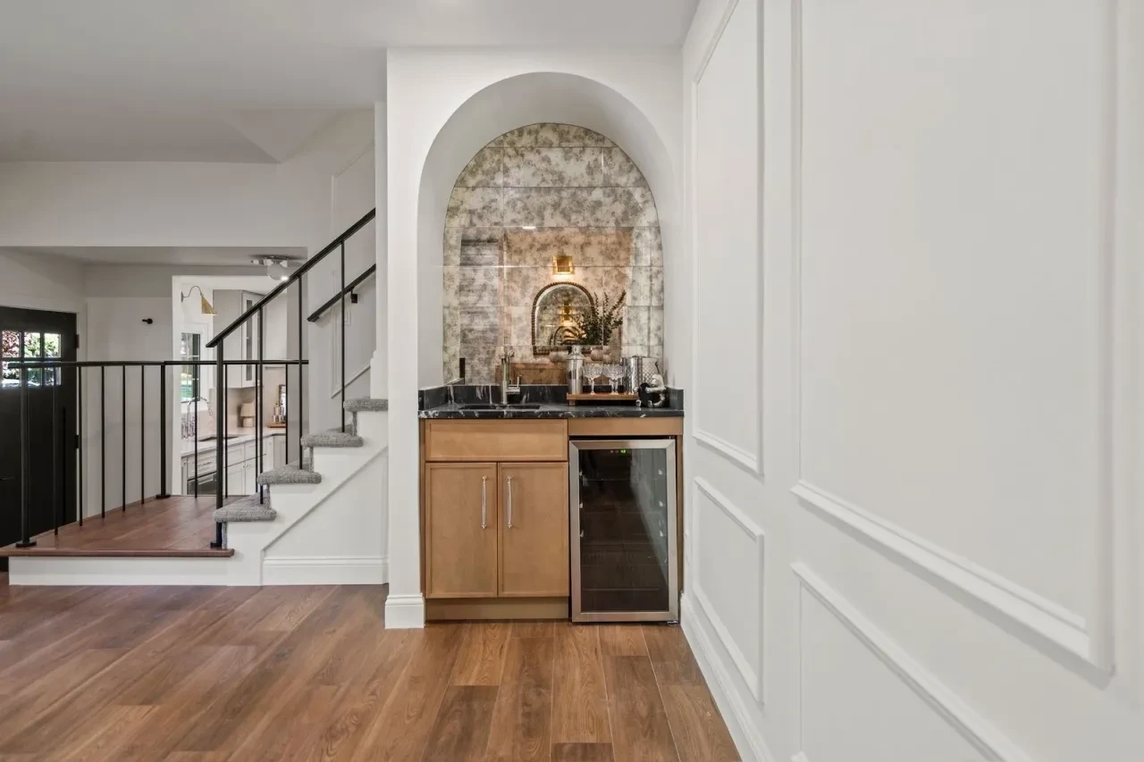 Minimalist interior with geometric wallpaper and arched doorway