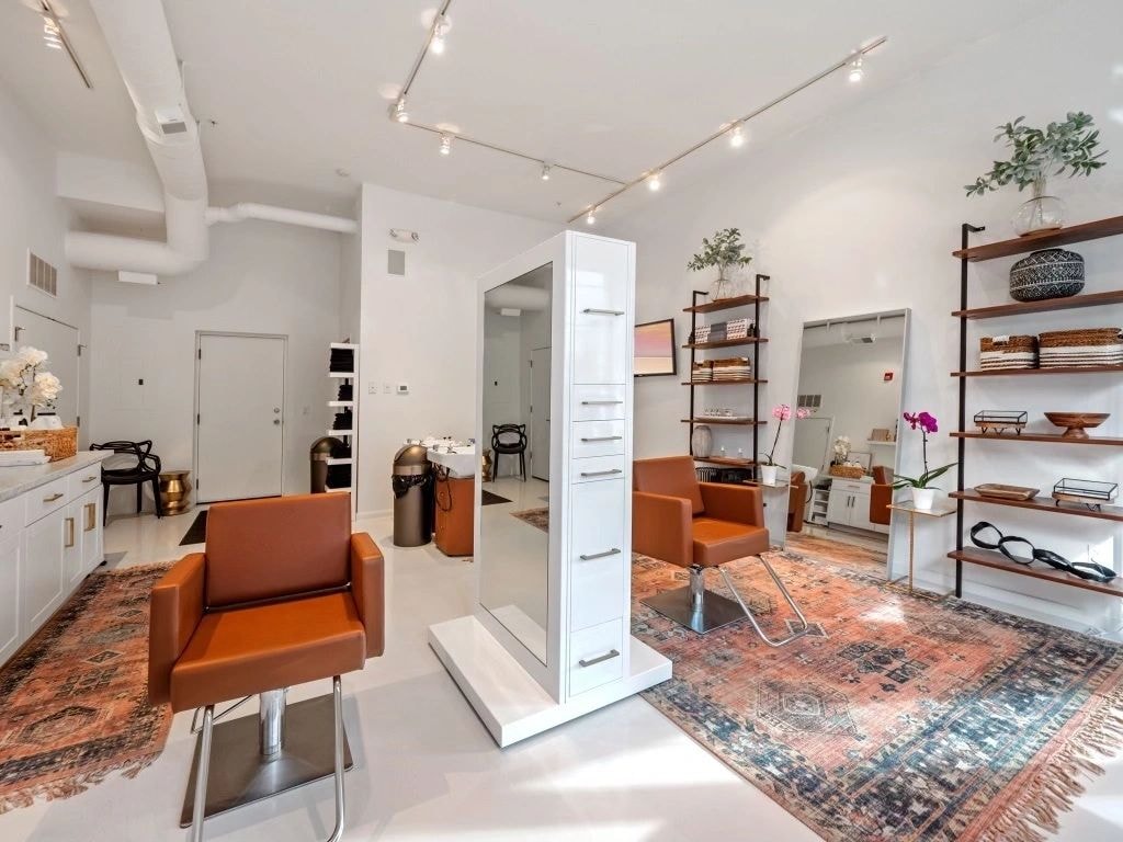 Spa salon interior with burnt orange leather chairs and wood accents