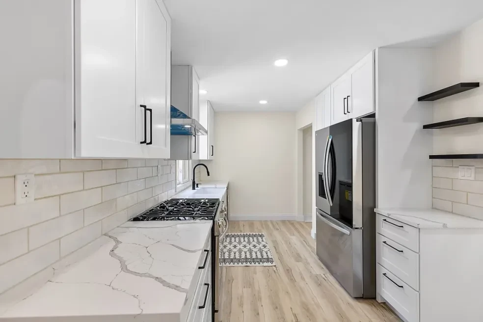 Moore Project — modern basement with green kitchenette and wood floors